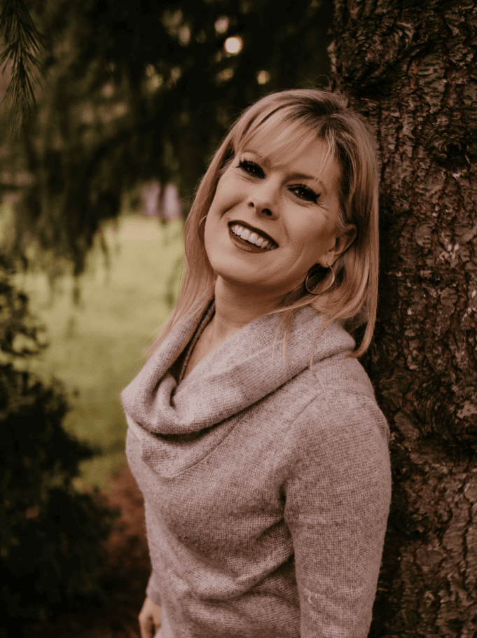 A woman leaning on the tree